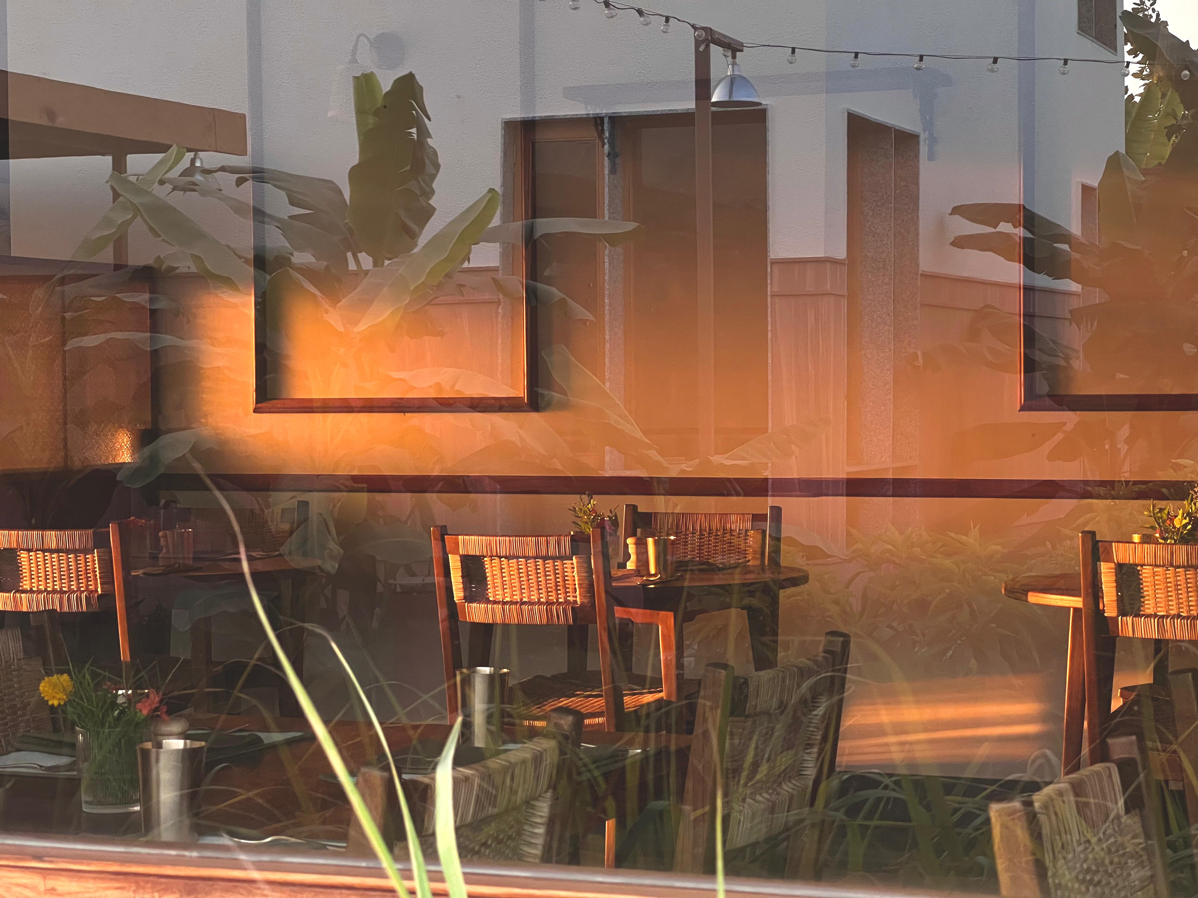 Dining tables seen through a sunlit window
